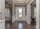 Inviting foyer with hardwood floors, neutral walls and a storm door to let the light in at 114 Reserve Ln, Fort Mill, SC 29707