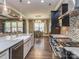 Open kitchen with stainless steel appliances, granite island, and a view to living and dining areas at 114 Reserve Ln, Fort Mill, SC 29707