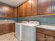 A well-equipped laundry room with modern washer and dryer units and storage cabinets at 114 Reserve Ln, Fort Mill, SC 29707