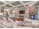 Open-concept living room has stone fireplace, coffered ceiling, and hardwood floors at 114 Reserve Ln, Fort Mill, SC 29707
