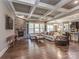 Spacious living room featuring a stone fireplace, coffered ceiling, and lots of natural light at 114 Reserve Ln, Fort Mill, SC 29707