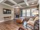 Inviting living room features stone fireplace, coffered ceiling, and hardwood floors at 114 Reserve Ln, Fort Mill, SC 29707