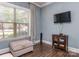 Bright living room with a TV, an ottoman, and a window with natural light streaming through at 114 Reserve Ln, Fort Mill, SC 29707