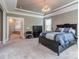 Serene main bedroom features plush carpet, a tray ceiling, and an adjacent ensuite bathroom at 114 Reserve Ln, Fort Mill, SC 29707