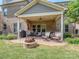 Covered outdoor patio area, complete with a fire pit and outdoor seating area at 114 Reserve Ln, Fort Mill, SC 29707