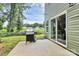 View of backyard patio showcasing siding and sliding glass doors at 1218 Rosada Dr, Charlotte, NC 28213