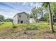 View of the fenced backyard, showcasing the house and adjacent building at 1218 Rosada Dr, Charlotte, NC 28213