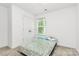 A bedroom with a plush carpet, a double door closet, a window offering natural light, and a patterned bedspread at 1218 Rosada Dr, Charlotte, NC 28213