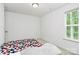 Bright bedroom featuring carpeted floors, a window with natural light, and a cozy beanbag chair for relaxation at 1218 Rosada Dr, Charlotte, NC 28213