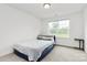 Inviting bedroom bathed in natural light from a large window, with minimalist decor at 1218 Rosada Dr, Charlotte, NC 28213