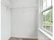 Bright closet with built-in shelving and natural light from the nearby window at 1218 Rosada Dr, Charlotte, NC 28213