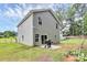 The back exterior of a two-story home showing siding and sliding glass doors to the backyard at 1218 Rosada Dr, Charlotte, NC 28213