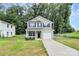 Charming two-story home with light green siding, black shutters, and an attached one car garage at 1218 Rosada Dr, Charlotte, NC 28213