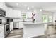 Bright kitchen with stainless steel appliances, white cabinets, and a gray granite countertop island at 1218 Rosada Dr, Charlotte, NC 28213
