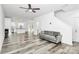 Open concept living room featuring modern gray flooring, neutral walls and ample natural light at 1218 Rosada Dr, Charlotte, NC 28213