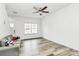 Clean living room featuring neutral walls, modern flooring and natural light from a window at 1218 Rosada Dr, Charlotte, NC 28213