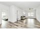 Spacious living area showcasing modern flooring, bright white walls, and open doorway to Primary at 1218 Rosada Dr, Charlotte, NC 28213