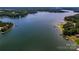 Stunning aerial view of a serene lake with lush greenery, offering a peaceful retreat and recreational opportunities at 122 Sleepy Cove Trl, Mooresville, NC 28117