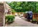 Charming wooden deck with an outdoor grill and comfortable seating, surrounded by lush greenery at 122 Sleepy Cove Trl, Mooresville, NC 28117