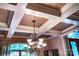 Detailed view of the coffered ceiling with a decorative chandelier, highlighting the architectural design at 122 Sleepy Cove Trl, Mooresville, NC 28117
