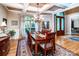 Dining room with hardwood floors, a coffered ceiling, and a decorative rug beneath the wood table at 122 Sleepy Cove Trl, Mooresville, NC 28117