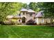 Charming brick home boasts mature landscaping and a meticulously manicured lawn at 122 Sleepy Cove Trl, Mooresville, NC 28117
