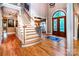 Inviting home foyer features a grand staircase and decorative front door at 122 Sleepy Cove Trl, Mooresville, NC 28117