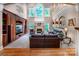 Spacious living room with a fireplace, large windows, and built-in shelving for entertainment at 122 Sleepy Cove Trl, Mooresville, NC 28117