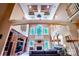 Spacious living room showcasing high ceilings, a fireplace, and built-in shelving for storage and display at 122 Sleepy Cove Trl, Mooresville, NC 28117