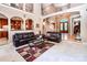 Open-concept living room with hardwood floors, a grand staircase, and a view of the front entry at 122 Sleepy Cove Trl, Mooresville, NC 28117