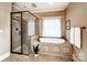 Bathroom features a walk-in shower, soaking tub, and neutral color scheme at 122 Sleepy Cove Trl, Mooresville, NC 28117