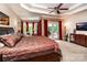 Spacious primary bedroom with coffered ceiling and seating area at 122 Sleepy Cove Trl, Mooresville, NC 28117