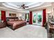Large primary bedroom featuring trey ceiling, ceiling fan, doors to backyard and sitting area at 122 Sleepy Cove Trl, Mooresville, NC 28117