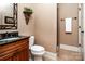 Stylish powder room featuring a decorative mirror, wood vanity and a tiled shower stall at 122 Sleepy Cove Trl, Mooresville, NC 28117