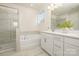 Stylish bathroom featuring glass shower, soaking tub, double vanity, and elegant tile floor at 125 Noah Ln, Troutman, NC 28166