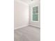 Clean and simple bedroom featuring neutral carpet, a large window, and ample natural light at 125 Noah Ln, Troutman, NC 28166