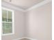 Bright bedroom corner with window, showcasing neutral walls and white trim at 125 Noah Ln, Troutman, NC 28166