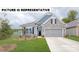 Charming single-Gathering home featuring stone accents, a two-car garage, and a well-manicured lawn at 125 Noah Ln, Troutman, NC 28166