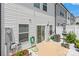 Backyard patio with a sliding glass door, white gravel and green plants at 13221 Gadwal Pintail Dr, Charlotte, NC 28262