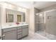 Elegant bathroom with double vanity, a large mirror, and a tiled walk-in shower at 13221 Gadwal Pintail Dr, Charlotte, NC 28262