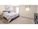 Comfortable bedroom with neutral carpeting and a large window provides ample light at 13221 Gadwal Pintail Dr, Charlotte, NC 28262