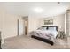 Spacious bedroom with neutral carpet, a cozy bed, and ample natural light at 13221 Gadwal Pintail Dr, Charlotte, NC 28262