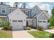 Beautiful townhome exterior with a two car garage, tidy landscaping, and welcoming entrance at 13221 Gadwal Pintail Dr, Charlotte, NC 28262