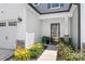Inviting front entrance with a well-maintained lawn, beautiful flowers, and a secure door at 13221 Gadwal Pintail Dr, Charlotte, NC 28262