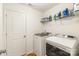 Functional laundry room with modern washer and dryer, plus convenient shelving and storage at 13221 Gadwal Pintail Dr, Charlotte, NC 28262