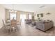 Living room with couches, dining table, lots of natural light, and hardwood floors at 13221 Gadwal Pintail Dr, Charlotte, NC 28262