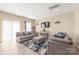 Living room with couches, TV, lots of natural light, and hardwood floors at 13221 Gadwal Pintail Dr, Charlotte, NC 28262
