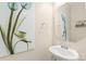 Elegant powder room features a pedestal sink, stylish mirror, and attractive decor at 13221 Gadwal Pintail Dr, Charlotte, NC 28262