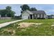 A single-story home with attached garage and well-maintained lawn with some hay spread out on the front yard at 1381 Steven Dr, Salisbury, NC 28147