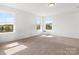 Bright bedroom with multiple windows, neutral walls, and carpeted floors at 1433 Harleston St, Indian Trail, NC 28079